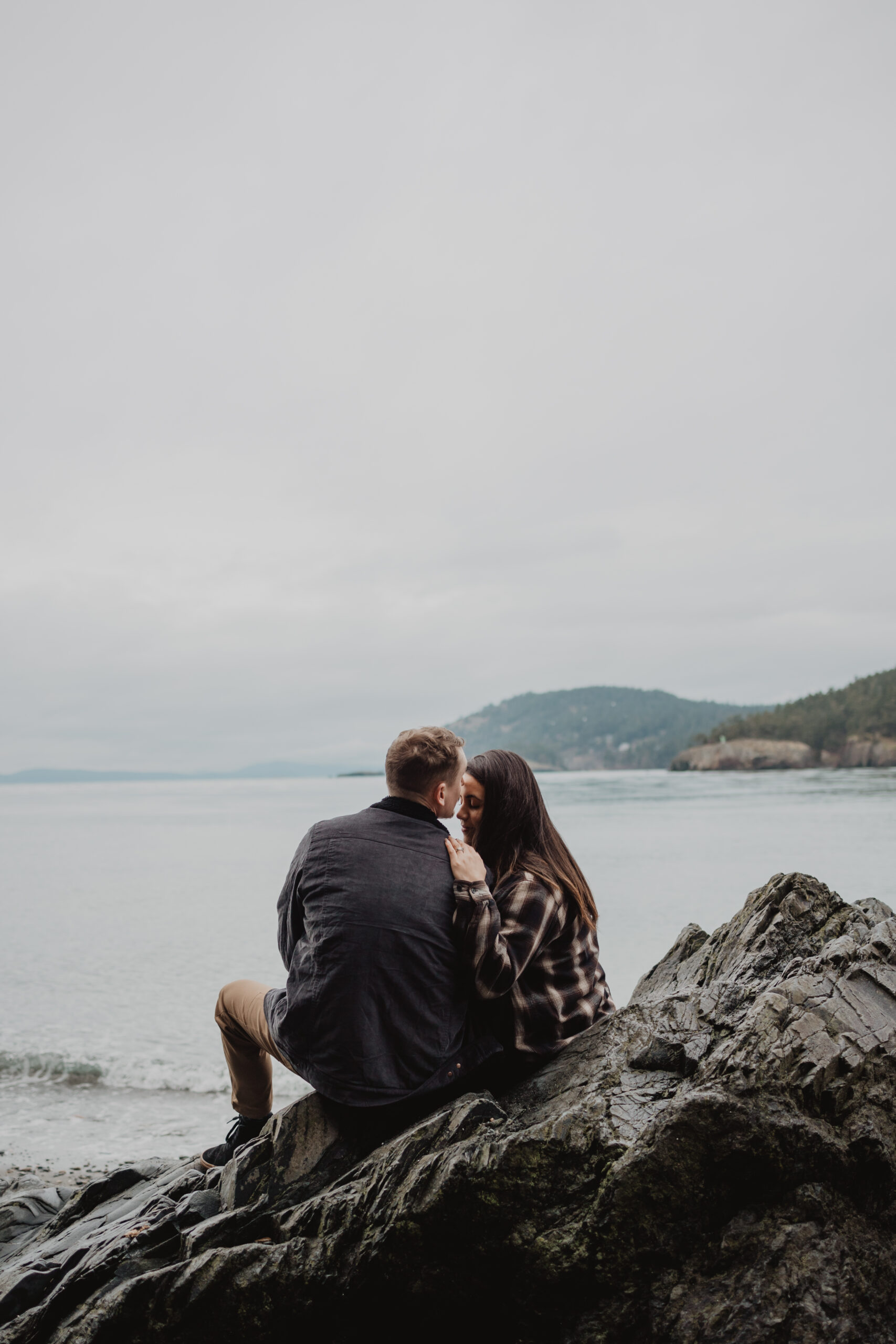 a couple posing together for their engagement session at Deception Pass State Park