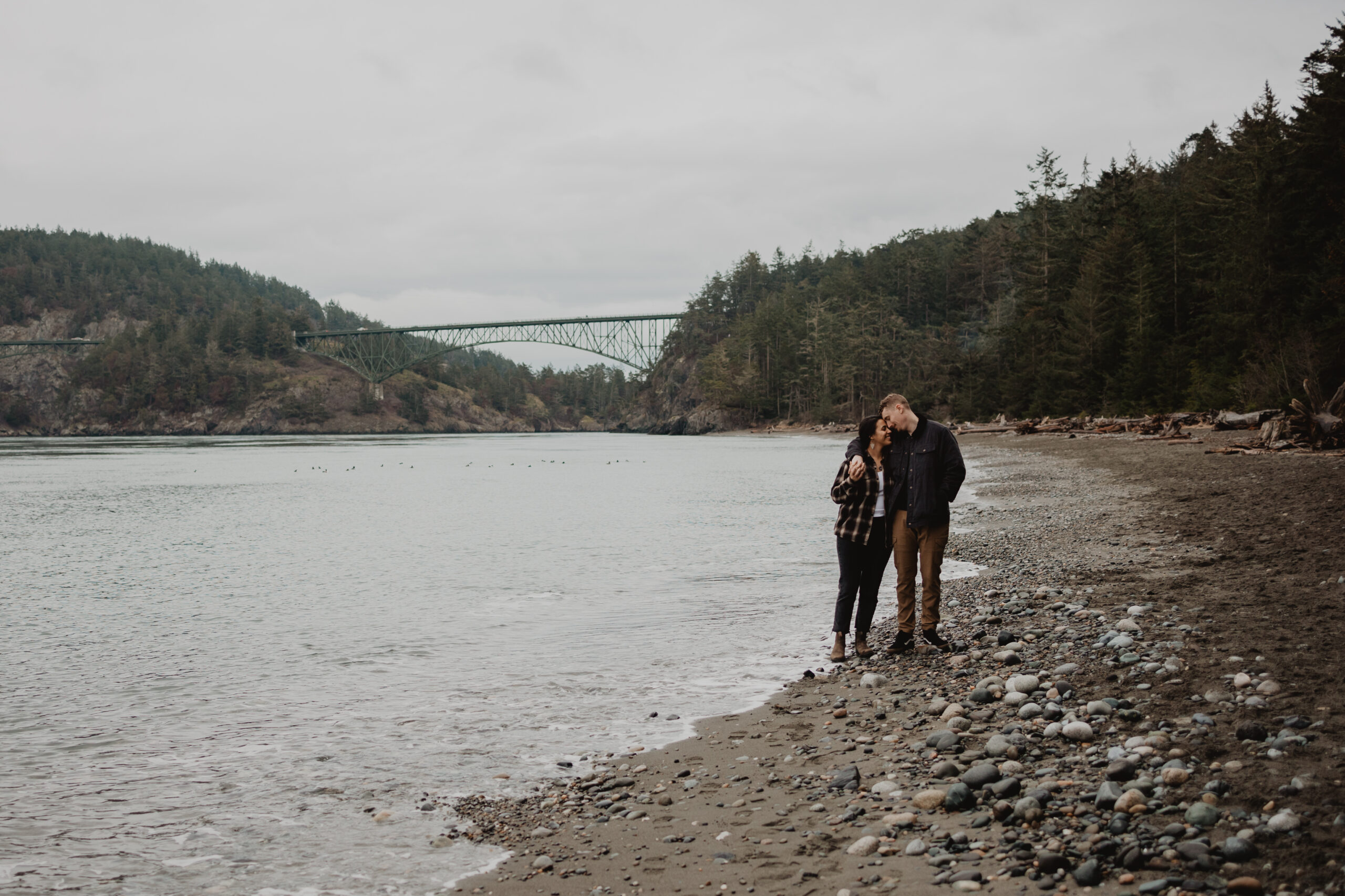 a couple posing together for their engagement session at Deception Pass State Park