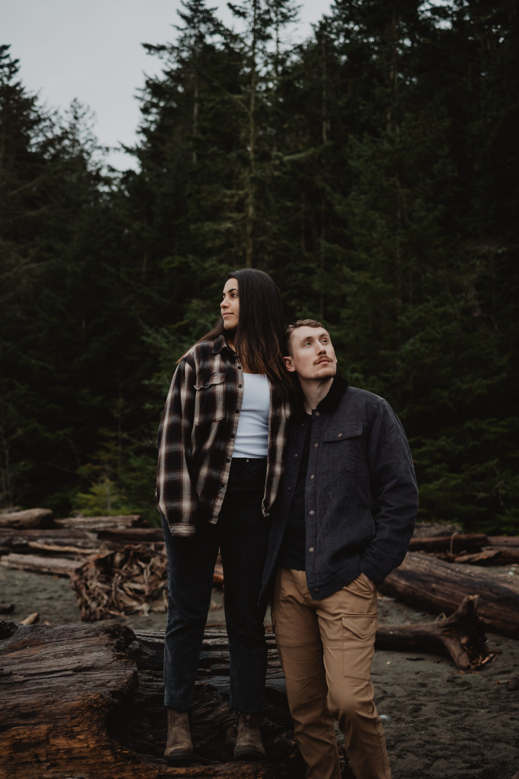 a couple posing together on the beach for their engagement session at Deception Pass State Park