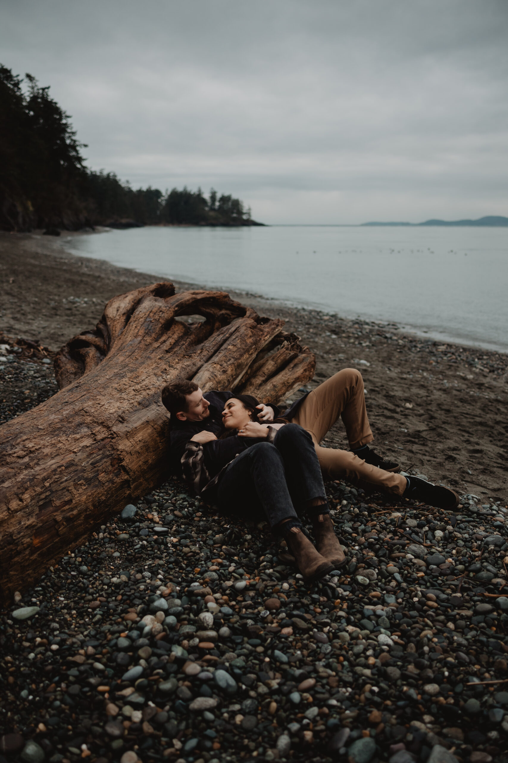 a couple posing together for their engagement session at Deception Pass State Park