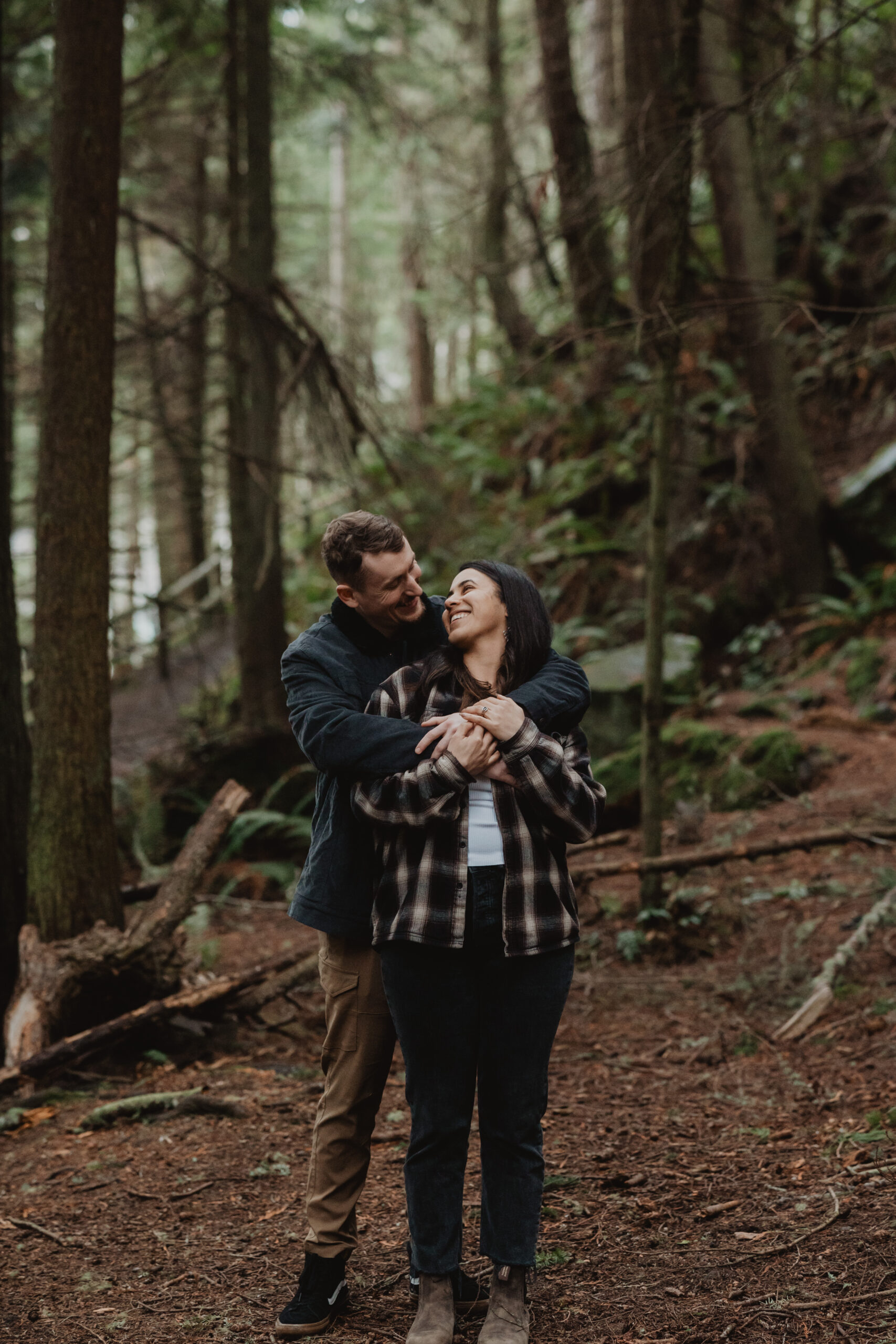 a couple posing together for their engagement session at Deception Pass State Park