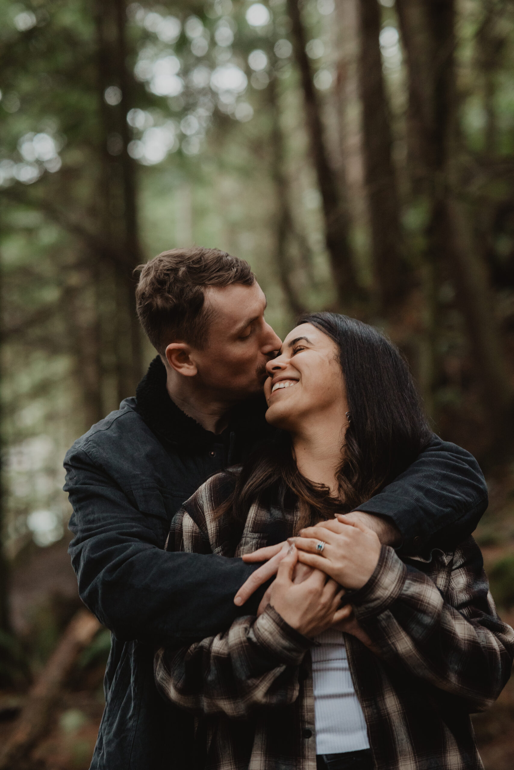 a couple posing together for their engagement session at Deception Pass State Park