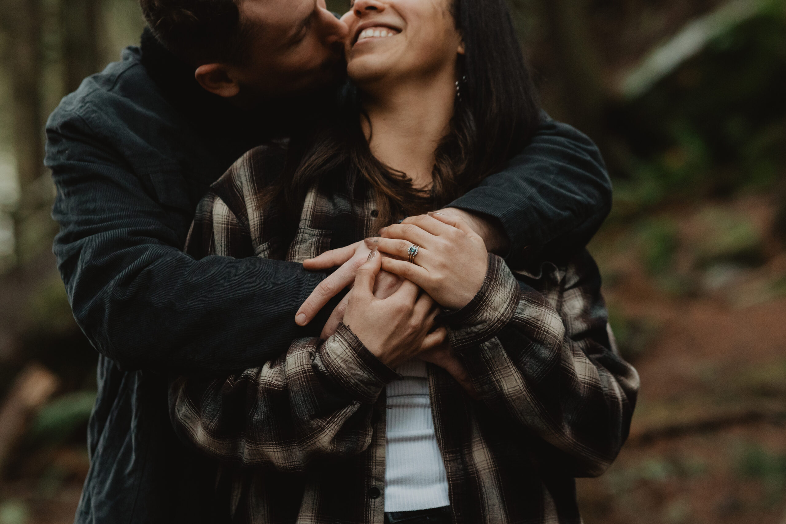 a couple posing together for their engagement session at Deception Pass State Park