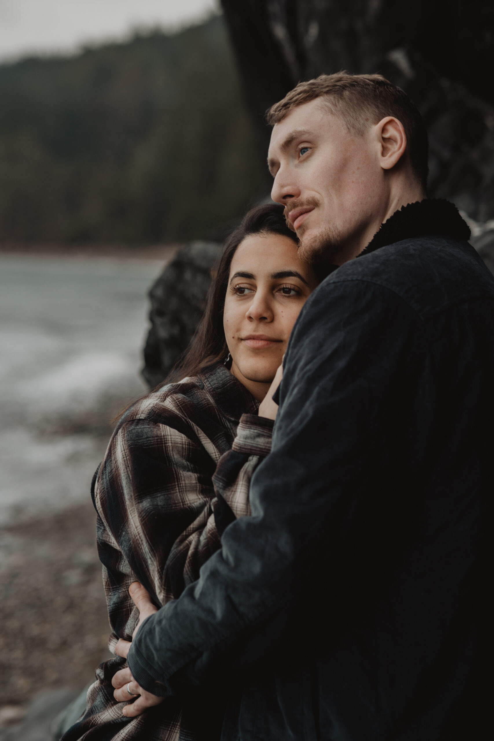 a couple posing together on the beach for their engagement session at Deception Pass State Park