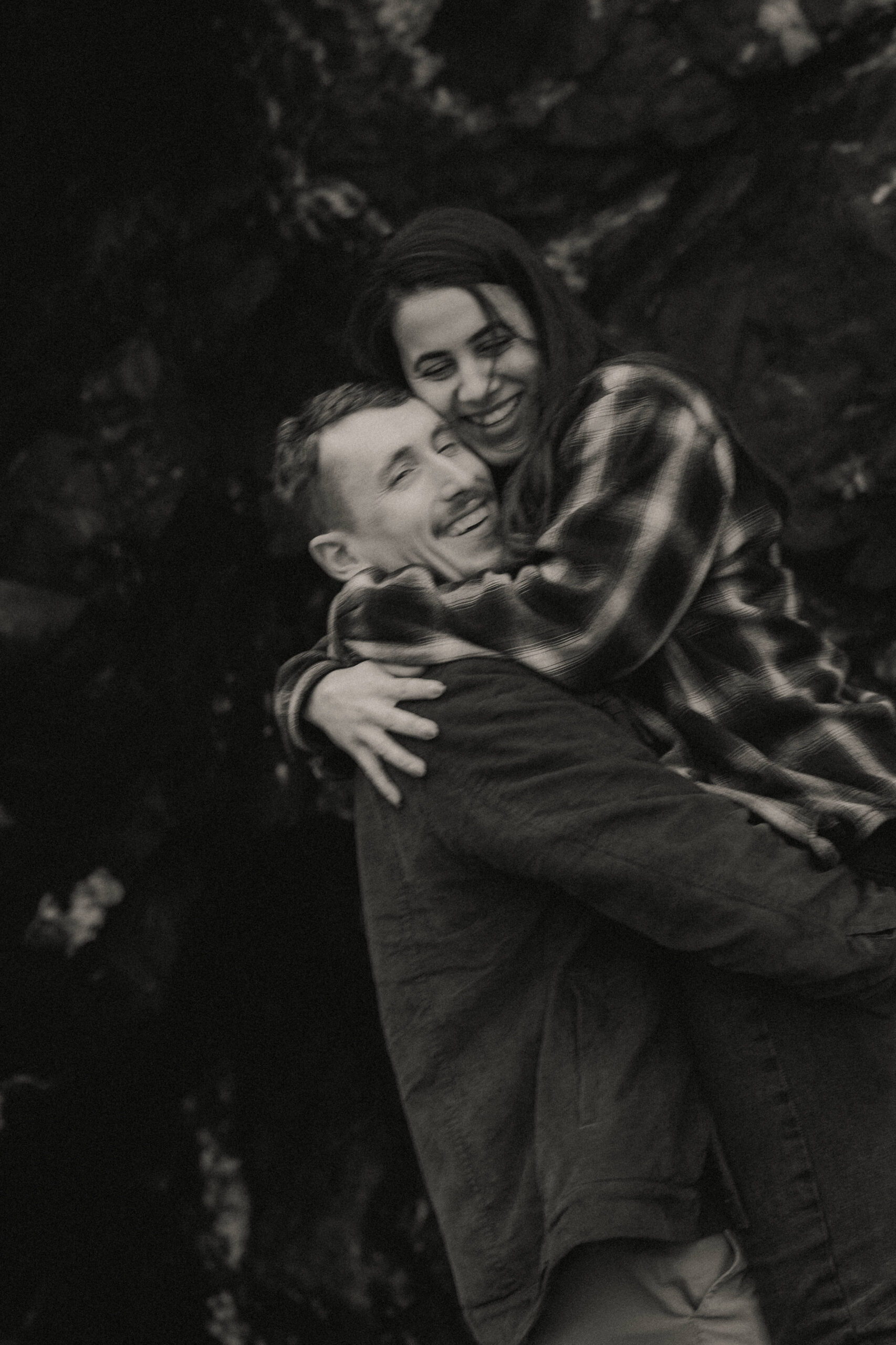 a couple posing together on the beach for their engagement session at Deception Pass State Park