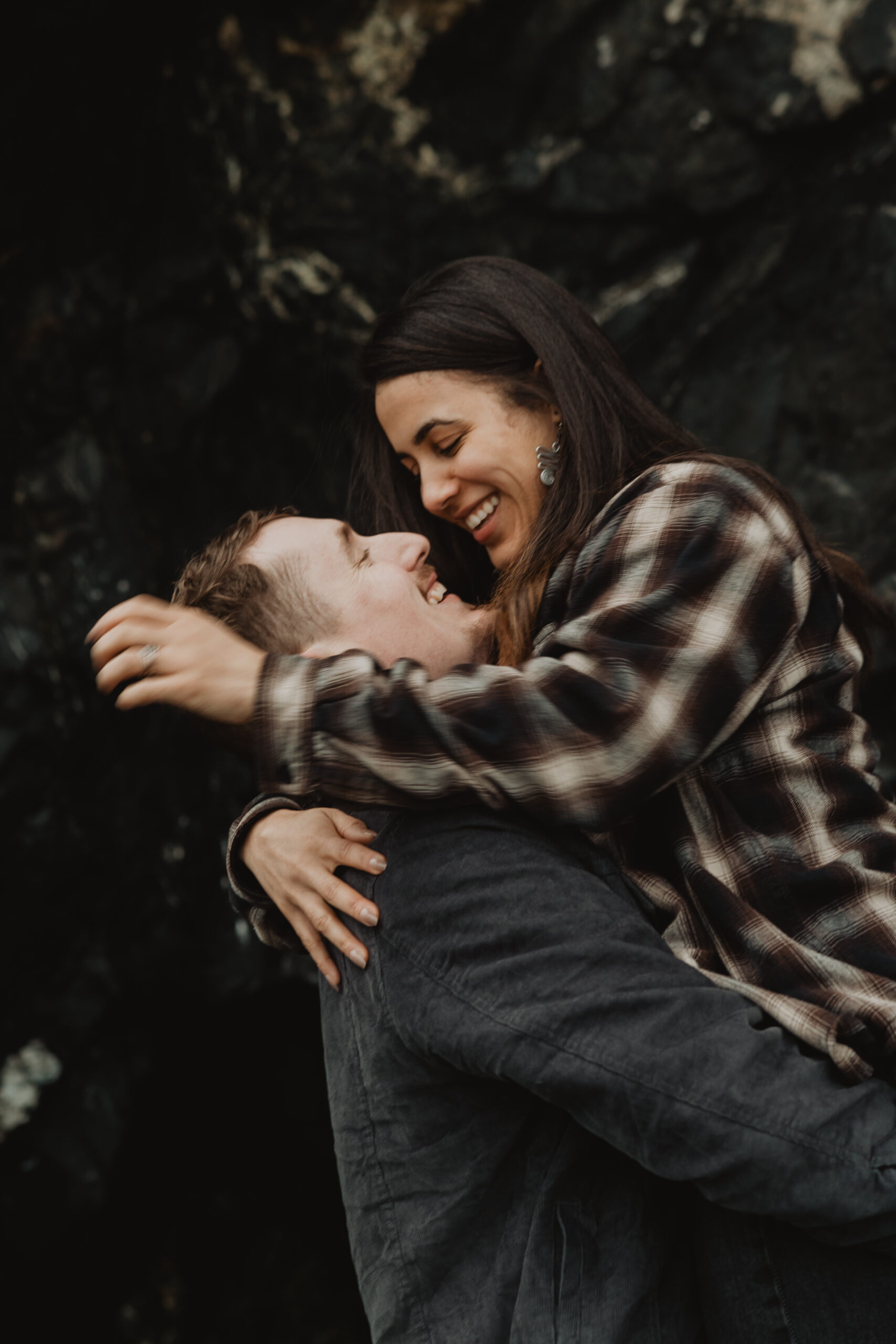 a couple posing together on the beach for their engagement session at Deception Pass State Park