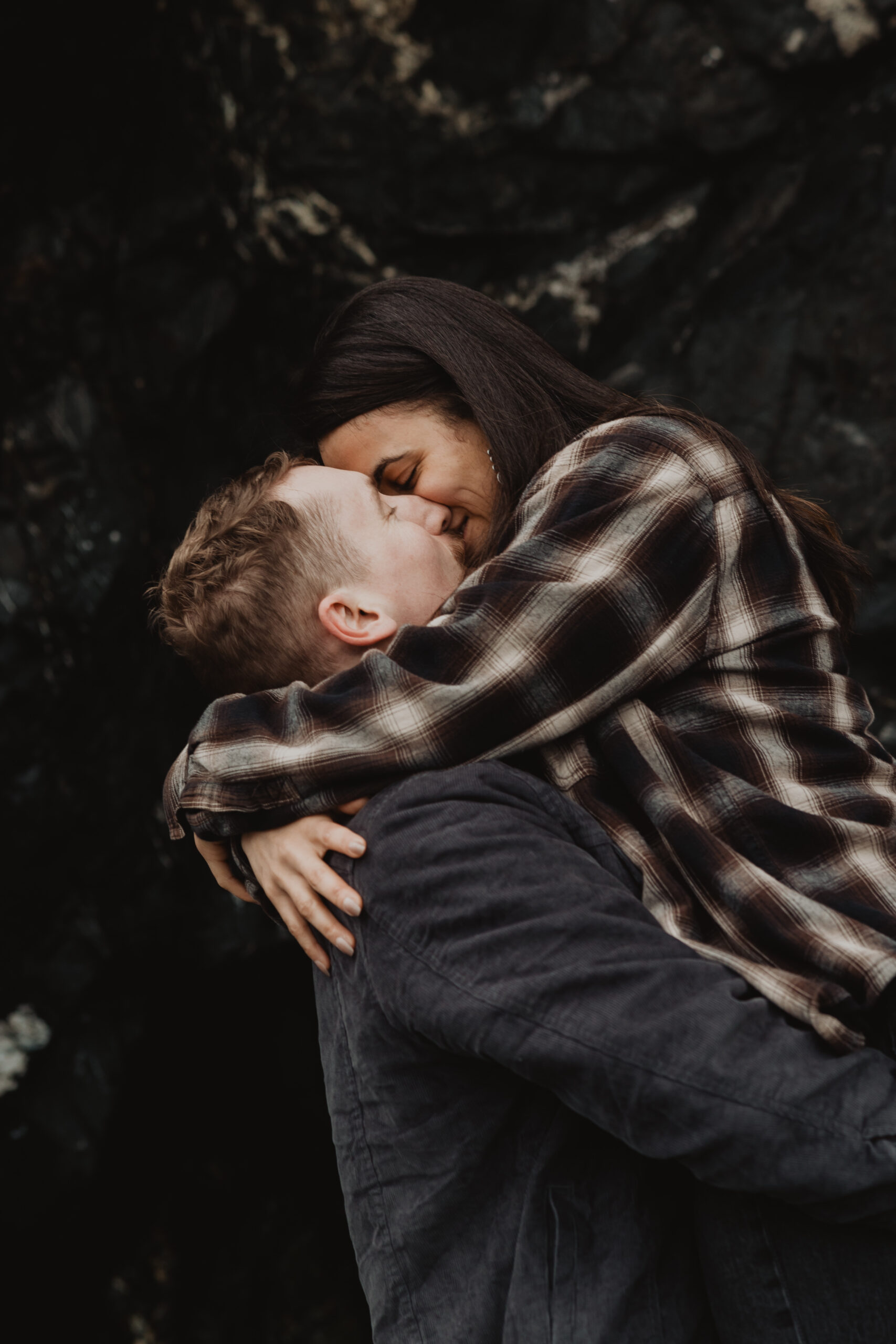 a couple posing together on the beach for their engagement session at Deception Pass State Park
