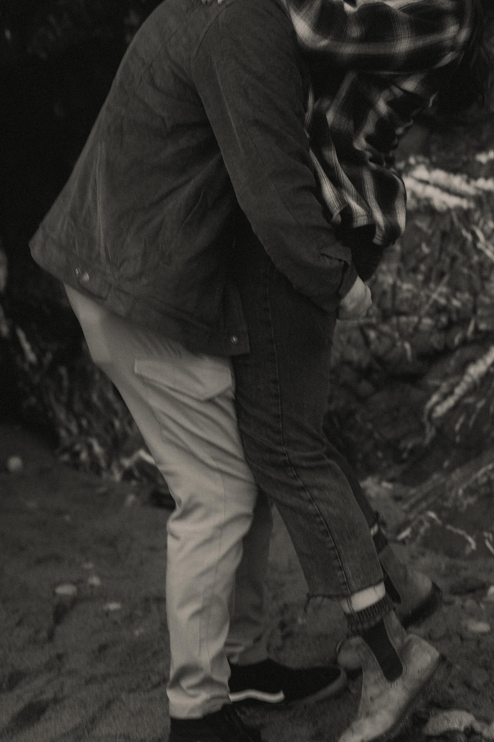a couple posing together on the beach for their engagement session at Deception Pass State Park