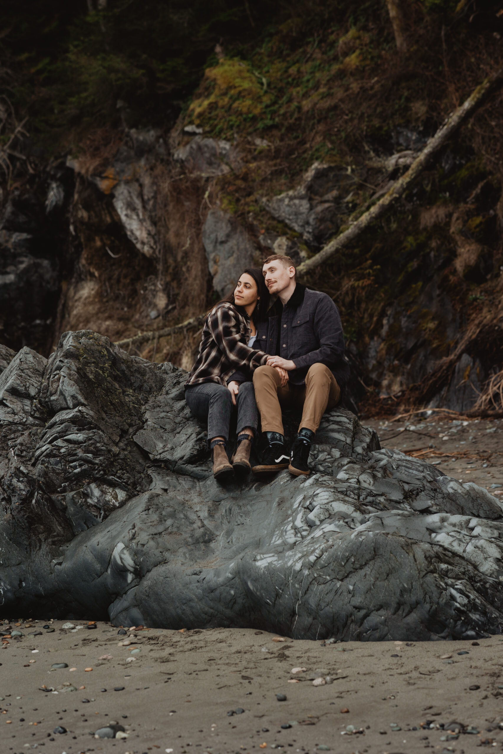 a couple posing together on the beach for their engagement session at Deception Pass State Park